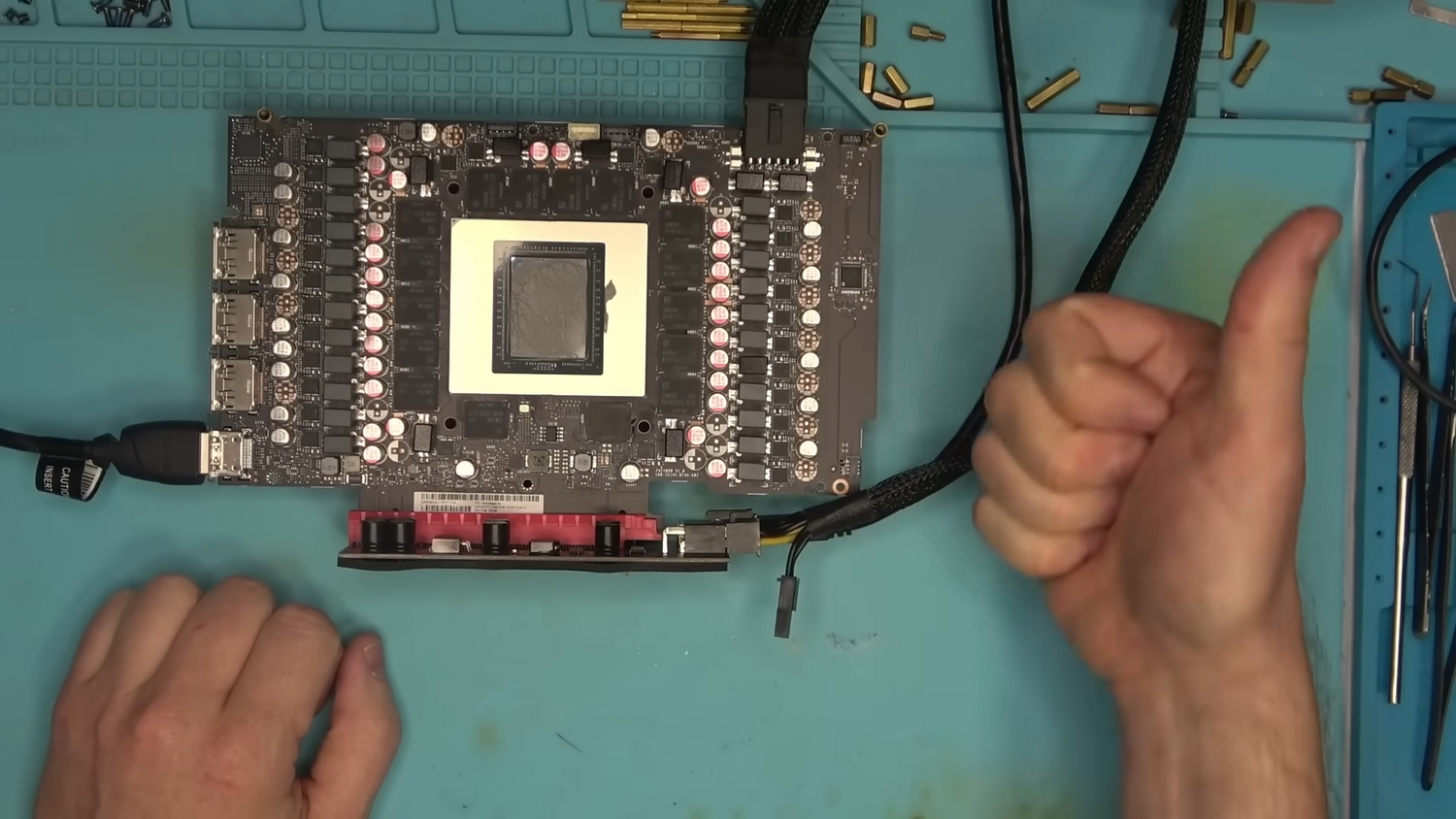 Dead RTX 5090 with a cracked PCB gets urgent surgery from repair wizard — tech casually reballs the core, replaces a memory chip twice, and runs more wires across its traces than the NSA