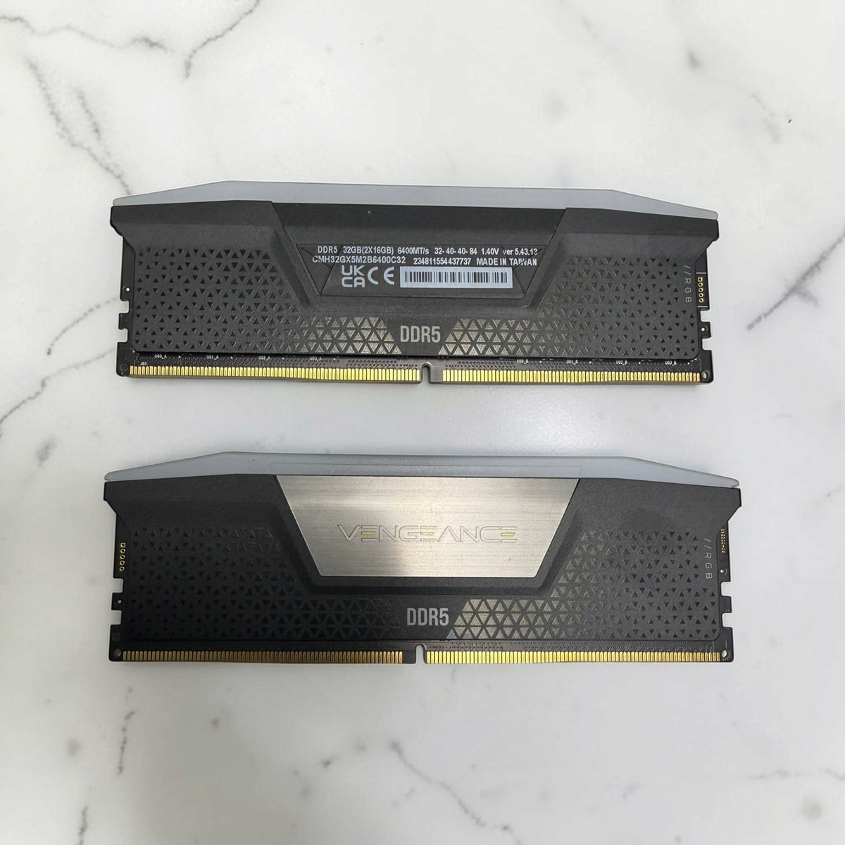 Corsair Vengeance RGB 32GB kit with two 16GB DDR5-6400 CL32 modules on a marble background